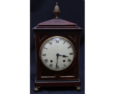 A Regency mahogany bracket clock, with cream painted circular dial and Roman numerals, set within a rectangular case with orm