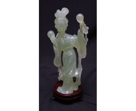 A contemporary jade figure of an oriental dancing lady holding percussion instruments. On wooden base. 17.5 cm.