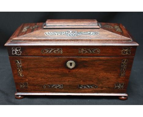 A 19th century rosewood tea caddy of sarcophagus form, inlaid with mother-of-pearl inlay, enclosed two tea canisters with hin