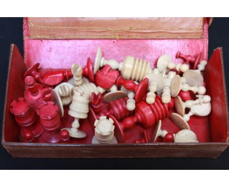 A complete early 20th century carved and stained bone chess set, the pieces principally of turned and ribbed form, in an asso