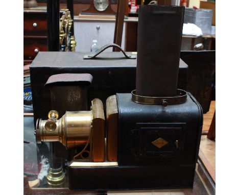 A W.C. Hughes tinplate magic lantern with original tin carry case