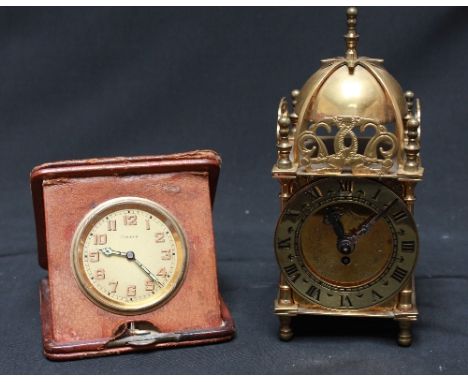 A brass cased Smiths 'lantern' clock and an eight-day folding travelling clock.