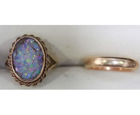 An unmarked high carat gold wedding band, and a gold and opal ring. Wedding band approx 7 grams (2).