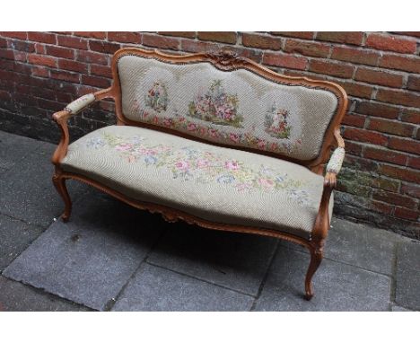 A French walnut-framed three-piece sofa suite in the Louis XV "Style," comprising a sofa and two armchairs, each with scrolli