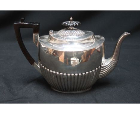 A Victorian silver oval teapot, hallmarked Sheffield 1900, with semi- fluted, body and ebony handle. 19.5 oz.