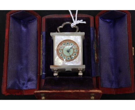 A late 19th/early 20th century mother of pearl miniature clock, set with pocket watch movement within a mother of pearl case 