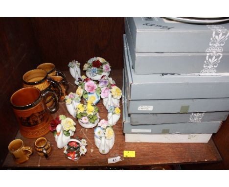 SECTION 43. A shelf lot of ceramics including collectors plates, flower vases and tankards.