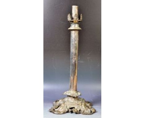 A 19th Century silver plated candlestick in the manner of Elkington having an ornate oak leaf top with relief decorated knop 