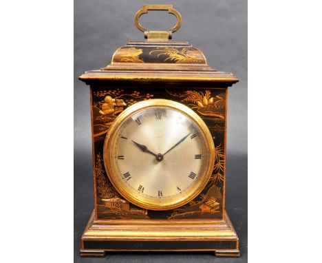 An early 20th Century French Chinoiserie mantel clock. The clock of square form with central circular dial set within the han