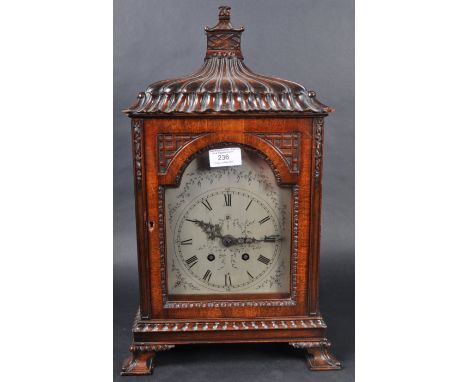 A 19th Century French mahogany pagoda bracket clock having a carved Chinese influence case with carved finial and arched glaz