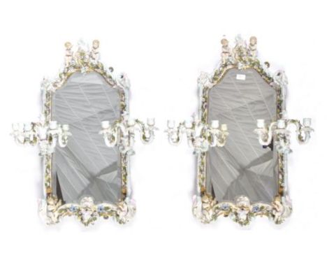 A pair of 19th Century large porcelain encrusted mirrors in the manner of Meissen. Both with two cherubs / putti seated to th