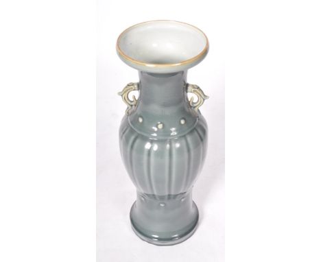 A large 19th Century Chinese Oriental ceramic urn vase of baluster form having a lipped rim with waisted neck and shaped hand