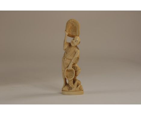 Carved ivory Okimono sculpture of a grapepicker,  waving his had, Japan ca. 1920-1940, h. 18 cm.   The item comes with a cert