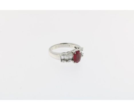 Below Dutch standard platinum ring, set with an facetted ruby,  ca. 1.30 ct and marquise and baguette cut diamonds, total ca.