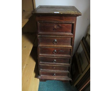 A PINE GRADUATED CHEST of six drawers with brass ring handles