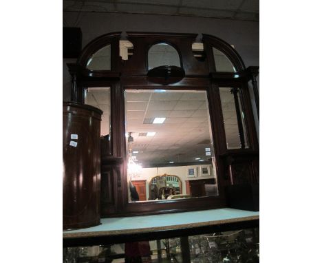 AN EDWARDIAN MAHOGANY COMPARTMENT OVERMANTEL MIRROR the rectangular bevelled glass plates with moulded frame and shelves join