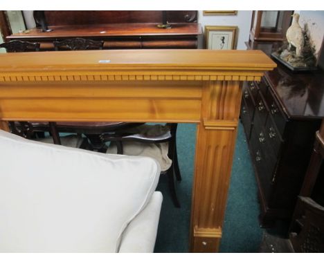 A PINE FIRE SURROUND the rectangular shelf with dentil moulded frieze raised on moulded jabs with scroll capital 124cm (h) x 