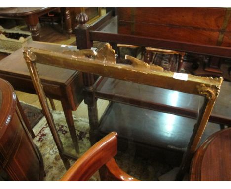 A CONTINENTAL GILTWOOD SCREEN the rectangular glazed panel within a C scroll and foliate moulded frame on standard end suppor