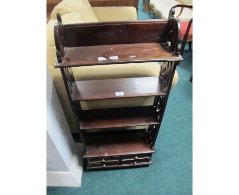 A MAHOGANY FOUR TIER WALL MOUNTED SHELF the base containing four short drawers on bracket feet 109cm (h) x 47cm (w) x 58cm (d