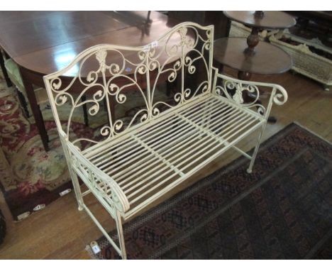 A CAST METAL GARDEN BENCH the serpentine top rail with scroll decoration on slatted seat with scroll arms 104cm wide