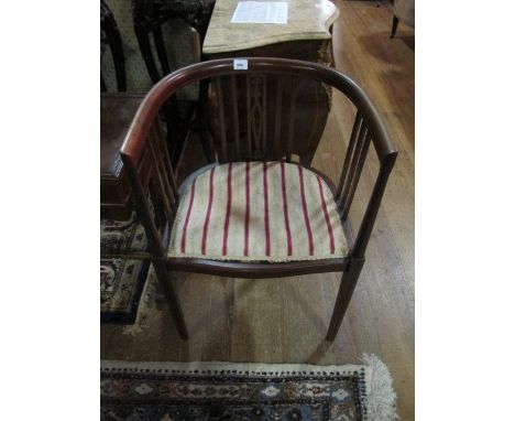 AN EDWARDIAN MAHOGANY TUB CHAIR with stick back uprights on square tapering legs