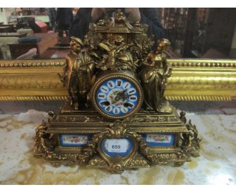 A LOUIS XVI STYLE FRENCH GILT METAL AND PORCELAIN MANTLE CLOCK the panels decorated with flowers