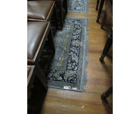 A PAIR OF WOOL RUGS each with a light blue ground decorated with flowerheads, foliage and flamingos within a foliate and flow