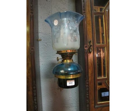 A VICTORIAN BRASS OIL LAMP supported on a pierced brass arm the light with etched shade