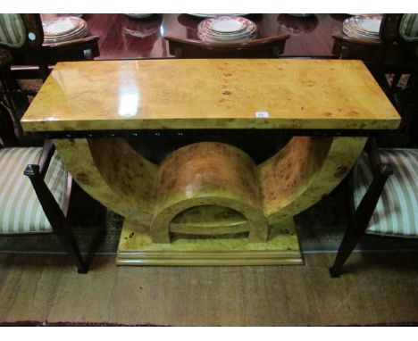 AN ART DECO STYLE WALNUT SIDE TABLE of rectangular outline the shaped moulded top raised on a U shaped support and stepped pl