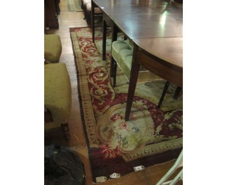 A WOOL RUG the beige and pink ground with central panel within a conforming border 303cm x 234cm 