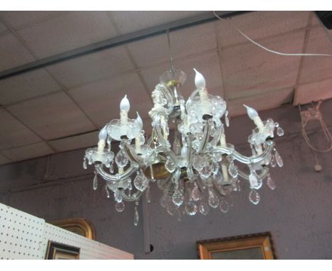 A CONTINENTAL TWELVE LIGHT CHANDELIER hung with pendant drops