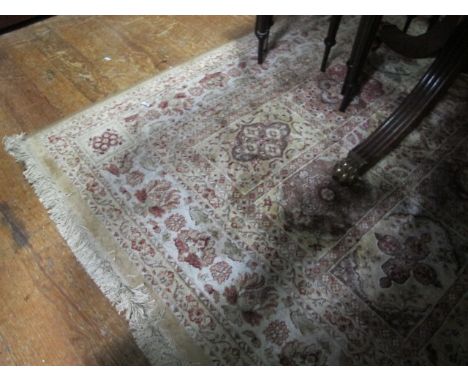 A WOOL RUG the beige light brown and green ground with panels filled with palmets within a floral border 236cm x 153cm