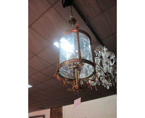 A CIRCULAR BRASS HALL LANTERN with scroll decoration and etched glass panels