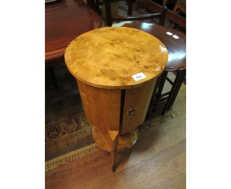 A PAIR OF ART DECO STYLE BURR WALNUT PEDESTALS each with a circular top and cupboard on slender cabriole legs joined by an un