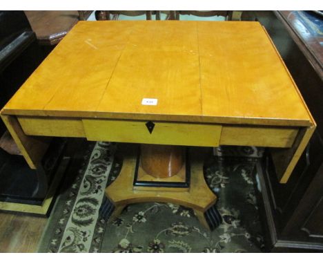A BIEDERMEIER SATIN BIRCH AND EBONISED SOFA TABLE the rectangular hinged top above a frieze drawer raised on a cylindrical co
