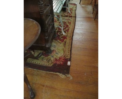 A WOOL RUG the beige and pink ground with central panel within a conforming border 303cm x 234cm 