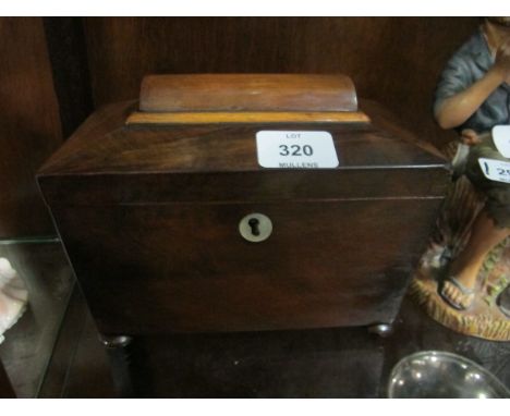A VICTORIAN MAHOGANY TEA CADDY of rectangular tapering form the hinged lid containing compartments raised on bun feet