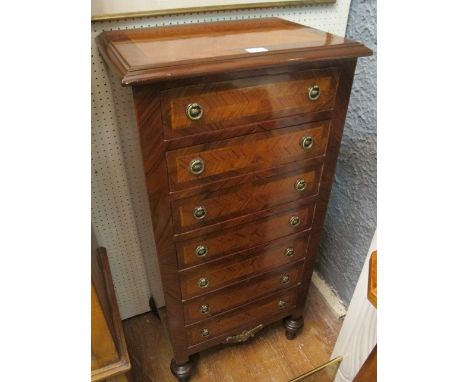 A CONTINENTAL ROSEWOOD AND WALNUT SEVEN DRAWER LOWBOY with quarter veneered top and drawers and brass ring handles 113cm (h) 
