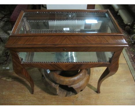 A CONTINENTAL KINGWOOD CURIO TABLE the rectangular hinged lid with glazed panel and cavetto frieze containing a mirrored inte