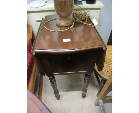 A WALNUT DROP LEAF TABLE of serpentine outline the shaped moulded top above a hinged cupboard raised on fluted and ring turne