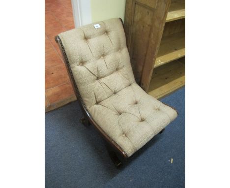 A MAHOGANY SCROLL LEG AND BUTTON UPHOLSTERED LOW NURSING CHAIR