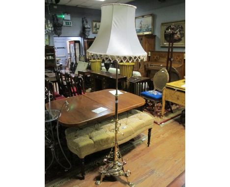A VICTORIAN BRASS FLOOR STANDARD LAMP the cylindrical column with barley twist and C scroll decoration above a platform base 
