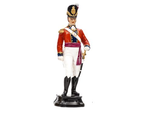 A Royal Worcester painted figure “Officer of the Coldstream Guards 1815”,in full dress with sword, on base, 12” overall. Near