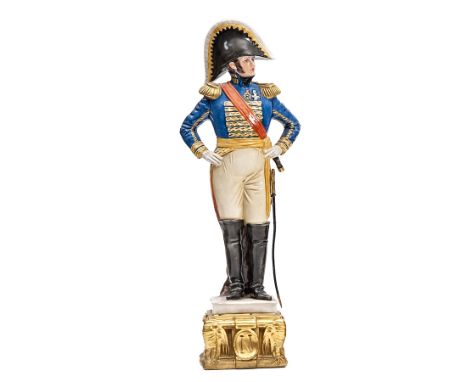 A painted porcelain figure of a Napoleonic naval officer,  in full dress with bicorne hat, sword and telescope, 11” overall. 