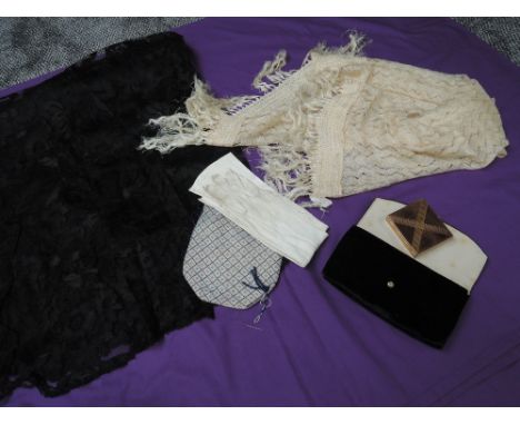 A small lot containing two antique shawls one with fringing, a beaded drawstring bag a pair of kid gloves and a black velvet 