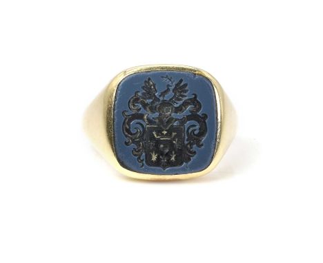 An onyx signet ring, with a cushion-shaped onyx intaglio, carved with the shield and crest of a Dutch family, mounted in unma