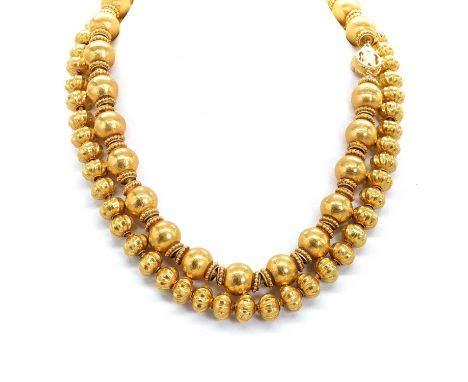 Two gold necklaces, both of Middle Eastern design, including a larger beaded necklace with hammered finish gold and ball edge