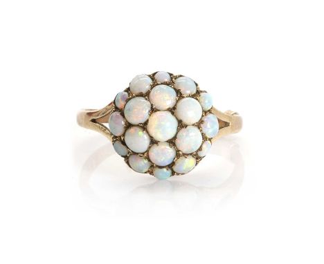 A 9ct gold opal bombé cluster ring,  with graduating round opal cabochons, all claw set, to bifurcated shoulders and a D prof