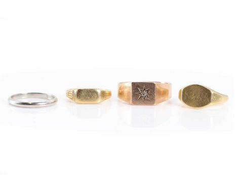 A group of three gold rings and a platinum ring, comprising an 18ct gold signet ring, Birmingham 1926, an 18ct gold engraved 