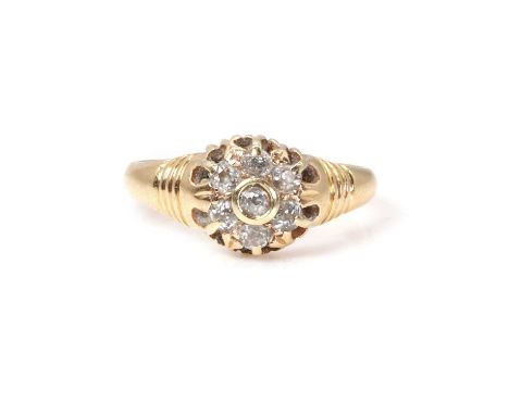 A late Victorian 18ct gold diamond cluster ring,  with a cluster of old cut diamonds, into an incised mount and shoulders, to